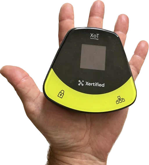 An XoT-S1 held in a hand. It is about the size of a palm.