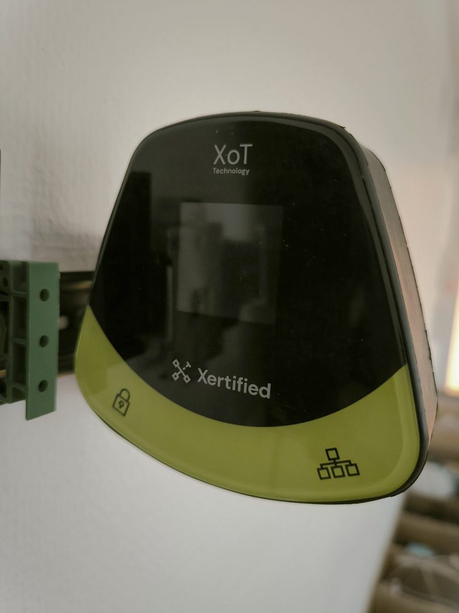 An XoT-S1 mounted on a DIN rail, seen at an angle from the side.