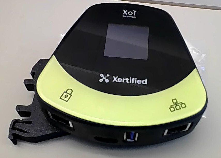 Close-up of the XoT-S1 showing the network ports and the DIN rail bracket.